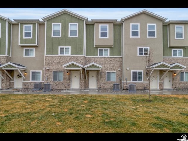96 E 670 N, Vineyard, UT 84059 - view of front of house with a front yard, brick siding, and stucco siding