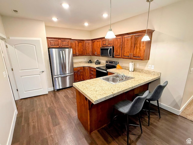 1768 W 300 S Unit D, Springville, UT 84664 - kitchen with stainless steel appliances, a peninsula, brown cabinetry, dark wood finished floors, and recessed lighting