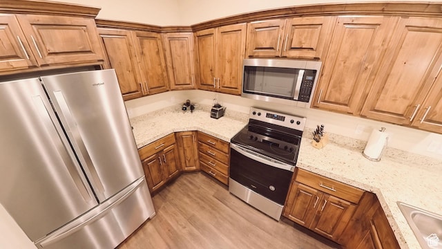 1768 W 300 S Unit D, Springville, UT 84664 - kitchen featuring stainless steel appliances, brown cabinets, and light wood-type flooring