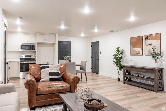 160 S 940 E, Santaquin, UT 84655 - living room featuring light wood-type flooring and recessed lighting
