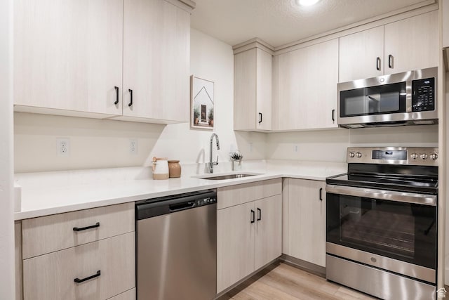 160 S 940 E, Santaquin, UT 84655 - kitchen with appliances with stainless steel finishes, light countertops, light wood-style floors, and light brown cabinetry