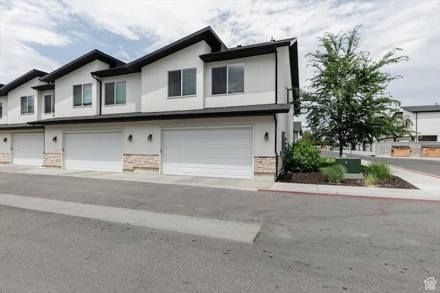 415 W 15 S, Providence, UT 84332 - view of front of home featuring stucco siding, a garage, and stone siding