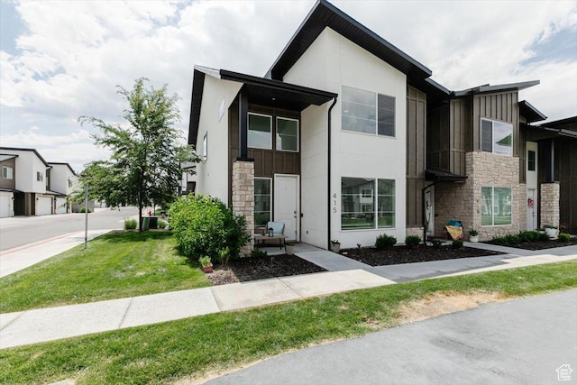 415 W 15 S, Providence, UT 84332 - modern home with stone siding, stucco siding, a front lawn, and board and batten siding