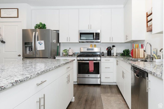 415 W 15 S, Providence, UT 84332 - kitchen with appliances with stainless steel finishes, white cabinets, dark wood finished floors, and light stone countertops