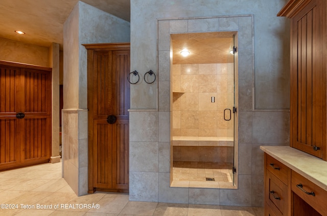 bathroom featuring tile patterned floors, vanity, and an enclosed shower