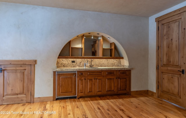 bathroom with backsplash, vanity, and wood-type flooring