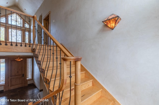 staircase featuring vaulted ceiling