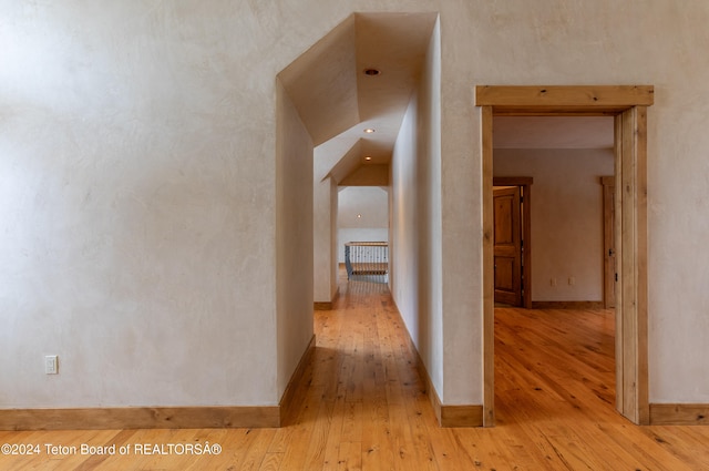 hallway with light hardwood / wood-style flooring