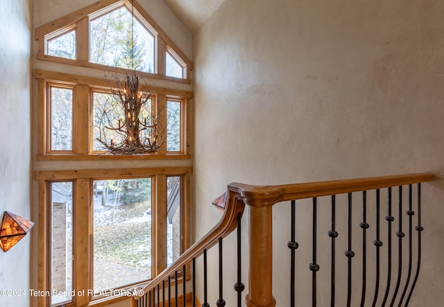 foyer entrance with a chandelier and lofted ceiling