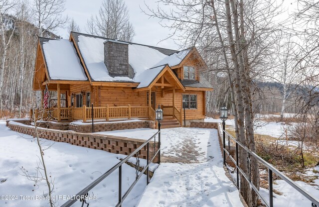 log home featuring a porch