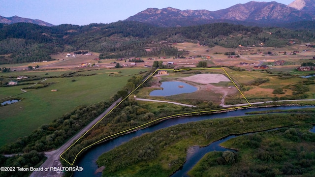 birds eye view of property with a water and mountain view