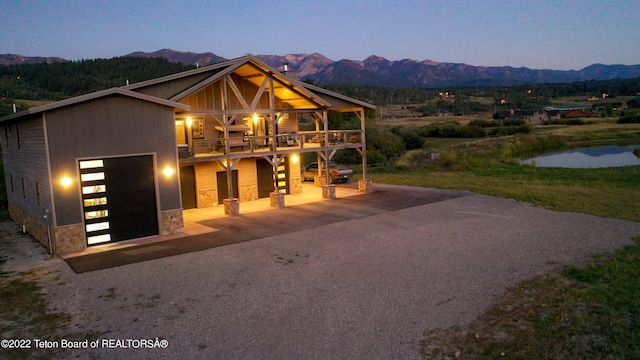 view of front of house featuring a balcony, a garage, and a mountain view