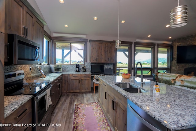 kitchen featuring sink, light hardwood / wood-style flooring, tasteful backsplash, and stainless steel appliances