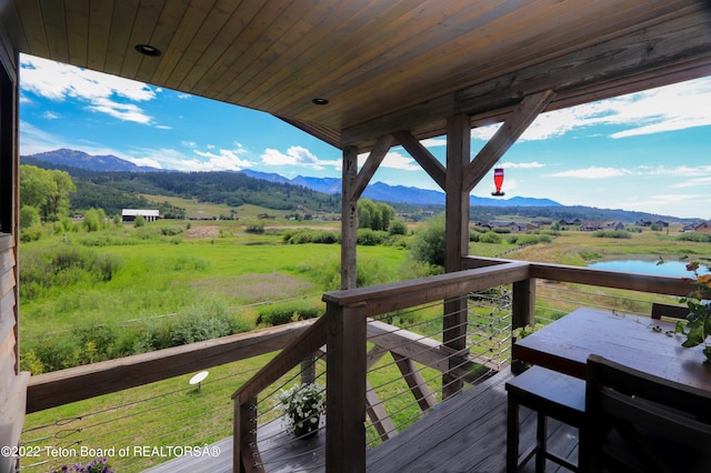 wooden deck featuring a mountain view and a rural view