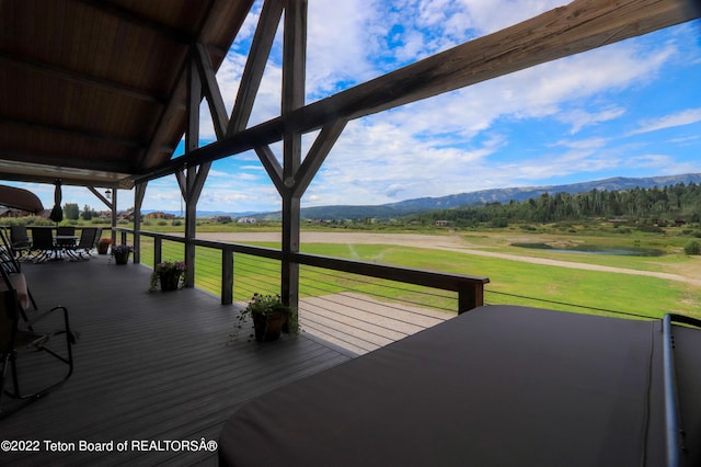 deck featuring a mountain view and a yard