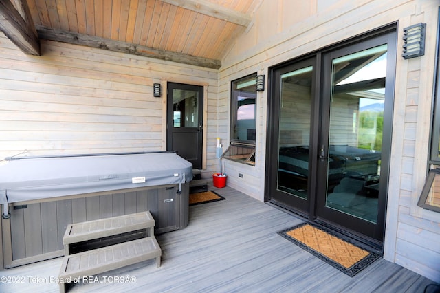 wooden deck featuring french doors and a hot tub