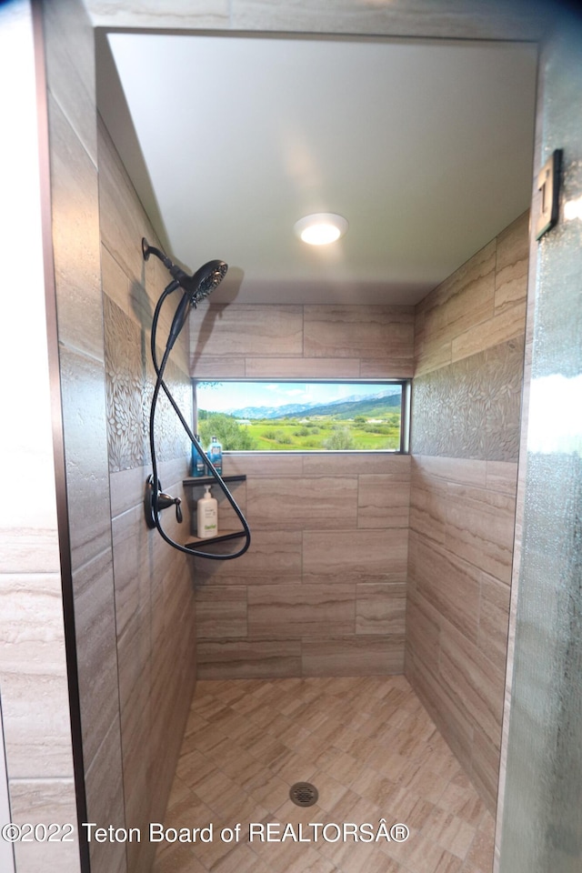 bathroom with tiled shower