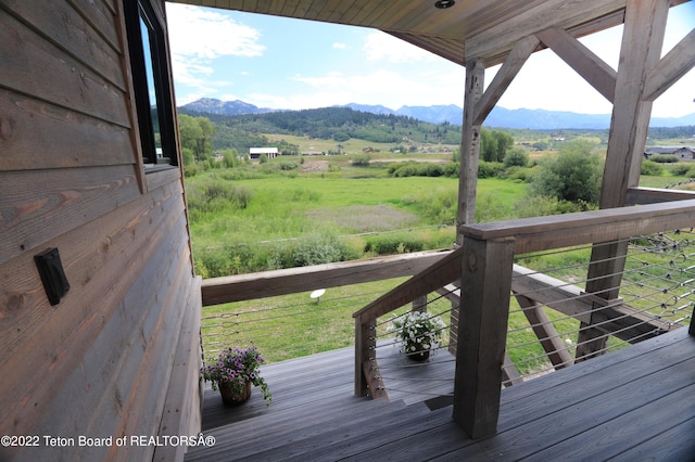 wooden deck featuring a mountain view and a rural view