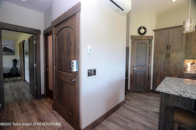 hall featuring dark hardwood / wood-style flooring and a wall mounted air conditioner