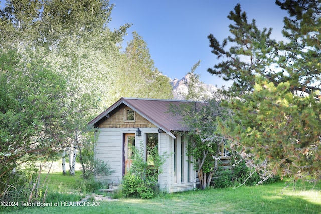 view of side of home with a lawn