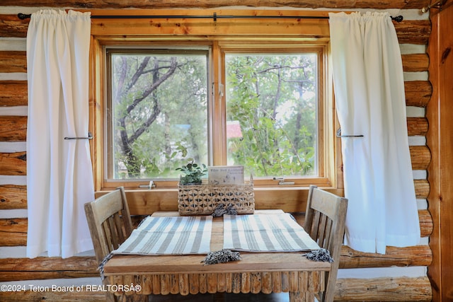 unfurnished dining area with log walls