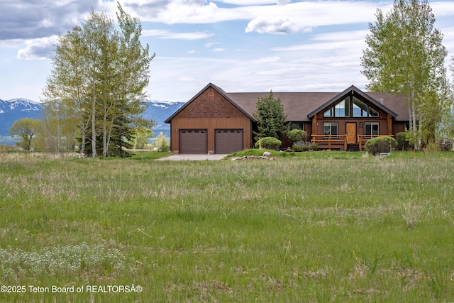 1515 Table Rock Dr, Driggs, ID 83422 - view of front of home with an attached garage and a deck with mountain view