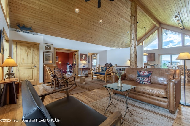 1515 Table Rock Dr, Driggs, ID 83422 - living room featuring high vaulted ceiling, light wood-style flooring, and wood ceiling with exposed beams