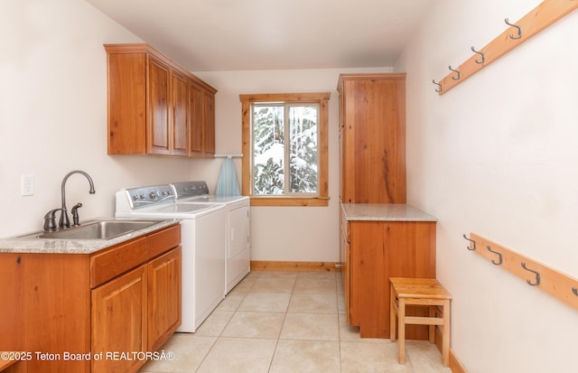 1515 Table Rock Dr, Driggs, ID 83422 - washroom featuring cabinet space, washer and clothes dryer, baseboards, and light tile patterned floors