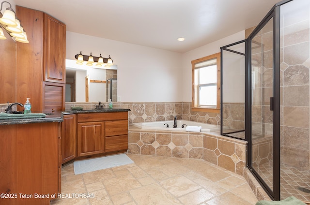1515 Table Rock Dr, Driggs, ID 83422 - full bathroom featuring vanity, a bath, stone tile flooring, a shower stall, and recessed lighting
