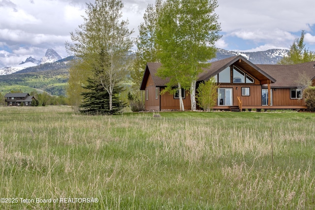1515 Table Rock Dr, Driggs, ID 83422 - view of front of property with a shingled roof and a deck with mountain view
