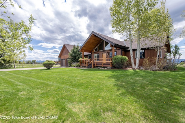 1515 Table Rock Dr, Driggs, ID 83422 - back of house with a wooden deck, a yard, and a garage