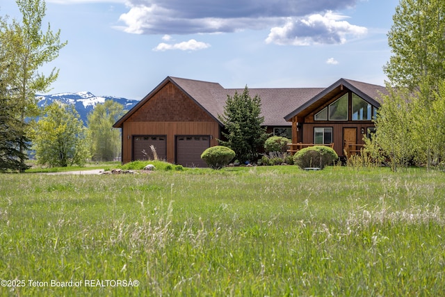 1515 Table Rock Dr, Driggs, ID 83422 - chalet / cabin featuring a garage, roof with shingles, and a mountain view