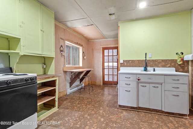 kitchen featuring dark tile flooring, white cabinetry, white electric range oven, and sink