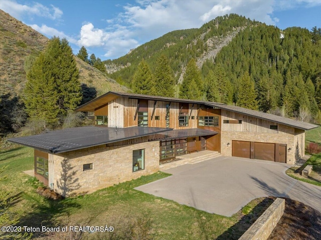 modern home featuring a mountain view and a garage