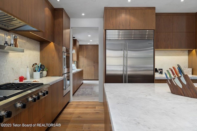 kitchen with stainless steel appliances and light hardwood / wood-style floors