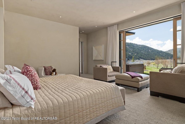 bedroom featuring light colored carpet and a mountain view