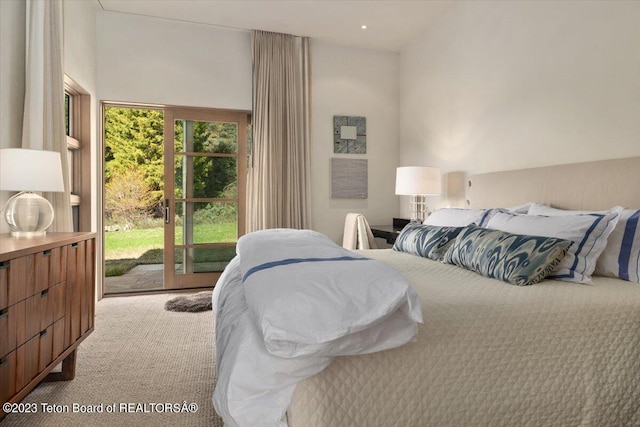 bedroom with light colored carpet, access to exterior, and a towering ceiling