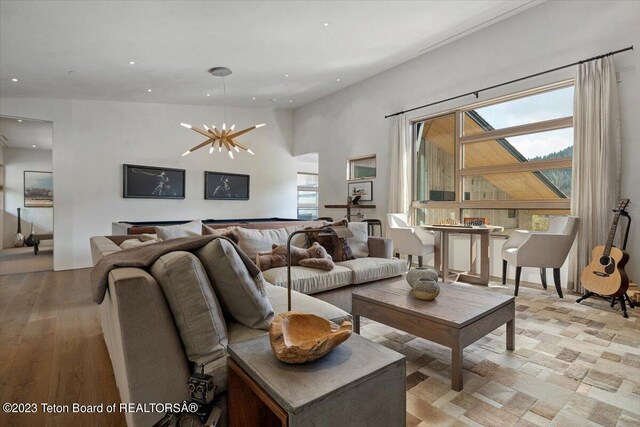 living room featuring an inviting chandelier and light hardwood / wood-style flooring