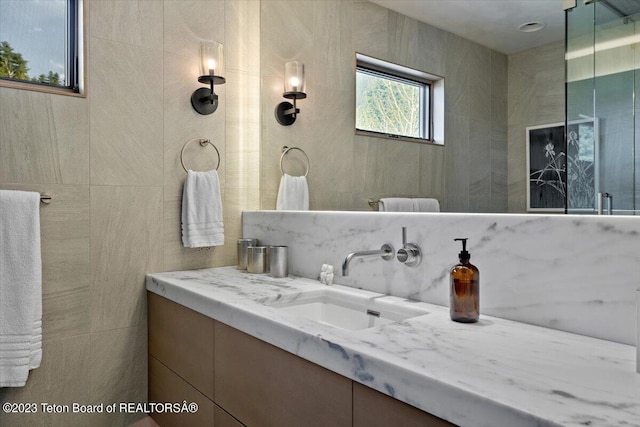 bathroom featuring tile walls and oversized vanity