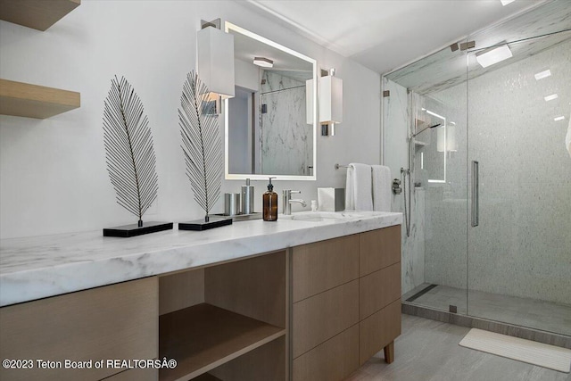 bathroom with walk in shower and vanity