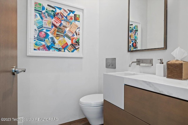 bathroom with toilet and large vanity