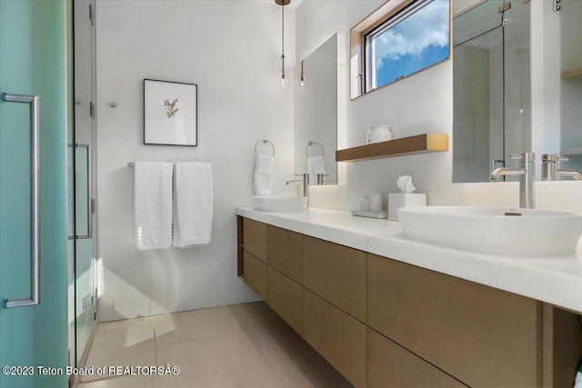 bathroom featuring walk in shower, tile floors, and vanity