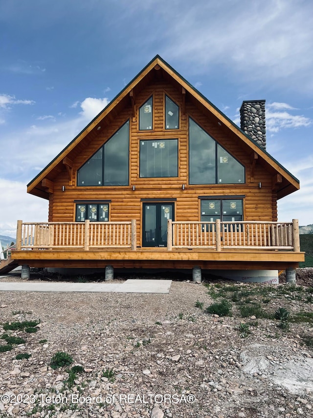 rear view of house featuring a deck