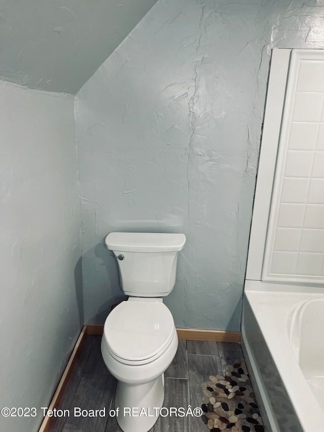 bathroom with toilet and tile flooring