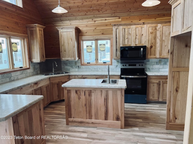 kitchen featuring stainless steel range with electric stovetop, light hardwood / wood-style floors, vaulted ceiling, and an island with sink