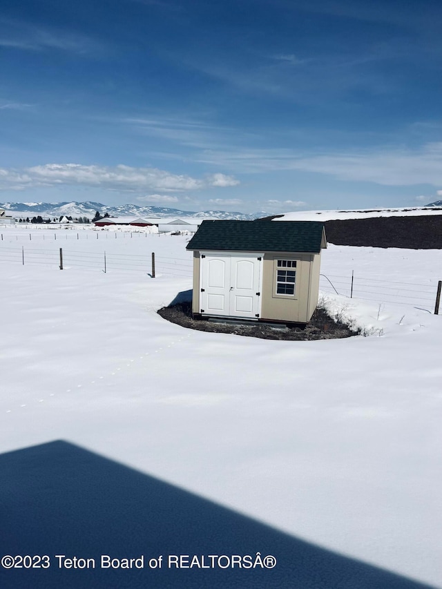 exterior space featuring a mountain view and a storage unit