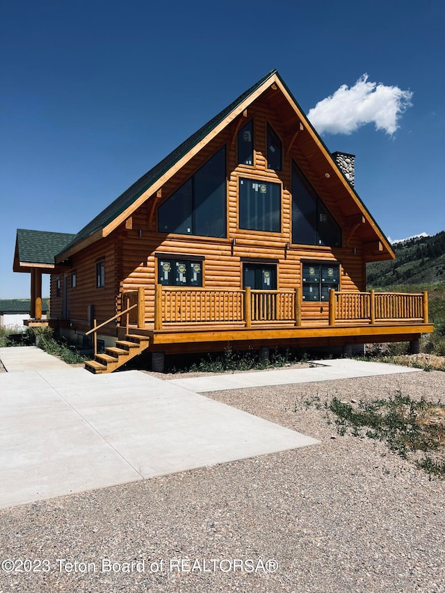 log-style house featuring a deck