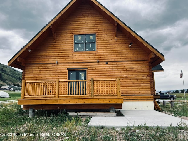 back of house with a wooden deck