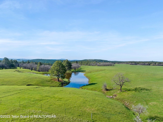 birds eye view of property with a rural view and a water view