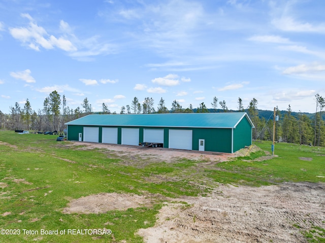 view of shed / structure with a yard and a garage